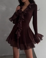 Close-up of deep V-neckline and layered ruffle trim on a chocolate brown mesh mini dress - S / Brown