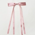Detail of pink satin bow hair clip with long flowing ribbons on white background - Skin Pink