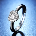 Macro shot of silver heart ring with multiple white pave diamonds on a blue background - Y121 Heart Micro Pave Halo