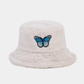 Close-up of soft plush bucket hat featuring a delicate blue butterfly embroidery detail - Beige