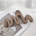 Matte khaki large wavy shark clip hair accessory on a minimalist magazine setup - 13cm / Brown