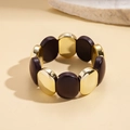 Detail view of retro geometric acrylic beads and gold metal segments on an elastic bracelet - Gold/Coffee