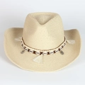 Detail of hand-woven straw cowboy hat featuring shell beads and ethnic tassel trim - Beige