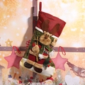 Festive burlap Christmas stocking with plush 3D reindeer holding skis in holiday scene. - Reindeer Design