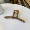 Close-up of brown hair claw clip with golden metal spring and smooth resin teeth detail - Transparent Brown