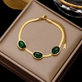 Vintage stainless steel gold snake chain bracelet featuring three oval emerald green stones - Gold Snake Chain with Oval Green Gemstones