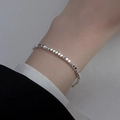 Macro shot of silver geometric bead bracelet with sparkling metallic luster on wrist - Silver Geometric Rhombus Particles (MY37939)