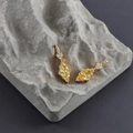 Macro shot of 18k gold plated earrings with marquise-cut yellow zircon and heart accent - Gold Base - Yellow Zircon