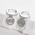 Macro detail of silver evil eye hoop earrings with micro-paved cubic zirconia stones - Silver-White Zirconia