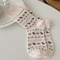 Pink and beige Fair Isle socks with grey cat and heart patterns in a cozy scene - One Size / Pink