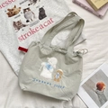 Detail of cute sheep and dog embroidery on light green canvas drawstring tote bag - Lamb and Bear