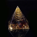 Orgonite pyramid with deep red crystal stones and golden spiral in resin - Garnet