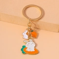 Detail of bunny and carrot metal keychain with colorful enamel coating on gold ring - Big Carrot Rabbit