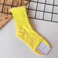 Detail of yellow ribbed knit cotton socks featuring a rolled cuff and authentic paper tag - One Size / Neon Yellow