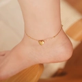 Gold minimalist heart pendant anklet with fine beads shown on ankle for women - Heart Anklet / Gold