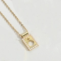 Gold pendant necklace featuring a vintage cross design with white pearls in a rectangle frame - Cross Silhouette Rectangle (Peach Heart Pearl)