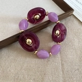 Deep and light purple acrylic beaded bracelet with golden accents on linen background - Bracelet-Purple