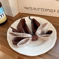 Elegant bow hair claw clip in brown and beige tweed fabric on a white vintage plate - Bow Banana Clip / Brown