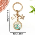 Gold ocean keychain with sea horse, starfish and shell pendant in a pearl circle frame - Green Enamel Seahorse Starfish Style (ER1923)