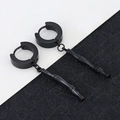 Detail of matte black bamboo-shaped pendant earrings with round hoops on textured background - Bamboo - Black