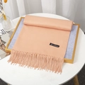 Thick light orange cashmere-like scarf with fringe tassels on a decorative tray - Apricot