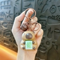 Cute brown capybara keychain holding a Mahjong tile with a creative rotating face design. - Glowing Pendant - Coffee