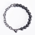 Detail of silver heart magnetic clasp connecting black beads and steel chain link bracelet - Magnetic Stone Bracelet