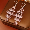 Detailed close-up of silver earrings with pink crystal hearts and zircon tassel fringe - Pink Ear Buckle