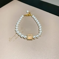 French style pearl bracelet with a gold square pendant featuring inset cat eye stone - Artificial Pearl Bracelet Style 85