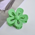 Close-up of green matte flower hair claw clip on a minimalist lifestyle background - Light Green