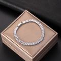 Close-up of silver tennis bracelet with rectangular zircons on a champagne gift box - 18cm Platinum Plated White Zircon