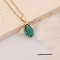 Macro detail of emerald zircon angel wing pendant with waterdrop stone on beige stone - Angel Wing Style (9#)