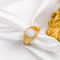 Detail of vintage 18k gold plated ring with oval white gemstone on white silk fabric - White Jade