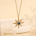 Detail view of 18K gold starburst evil eye pendant with green stone and crystals - Green Star-B4