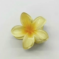 Macro detail of Frangipani hair claw with yellow gradient resin and flower design - Yellow