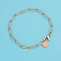 Detail of rose gold paperclip chain bracelet with a square charm and lobster clasp - Rose Gold / 17cm