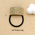 Close-up of golden metal hair tie with five rows of sparkling rhinestones and black band - Golden Multi-Row Rectangle Rhinestone