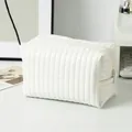 Minimalist white quilted toiletry bag with vertical stitching and smooth zipper closure - Candy Leather White