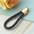 Portachiavi in pelle nera intrecciata con chiusura a cuore dorata e decori eleganti - Corda Cuore / Nero