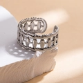 Detailed view of silver stainless steel chain ring on a white decorative stone base - Steel Color 37-1