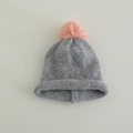 Close-up of grey knit winter hat featuring a soft pink faux fur pompom and ribbed cuff - 3-8 Years / Grey (Pink Pom)