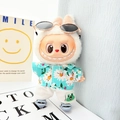 Plush doll in green floral shirt, frog shorts, blue sandals and sunglasses outfit - Blue Shark Shoes + Sky Blue Beach Outfit / First And Second Generation Keychains Are Compatible With La Cloth Dolls. Dolls Not Included.