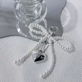 Cute faux pearl bow bag charm with a polished silver heart pendant and metal clasp - Faux Pearl Bow & Heart