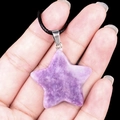 Natural purple amethyst star pendant necklace with black cord held in hand - 30mm Lilac Stone