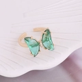 Macro view of adjustable gold butterfly ring with green glass wings on a shell tray - One Size / Peacock Green