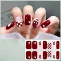 Macro view of Christmas gingerbread man and checkered pattern gel nail stickers - CS433