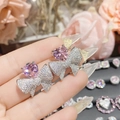 Detail of 18K gold-plated bow earrings featuring pink heart gemstone and pavé zircons - 0180 Pink Heart Gem Bowknot Studs