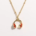 Close-up of golden ball chain necklace featuring a red enamel headphone pendant detail - Red Headphones