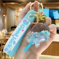 Blue quicksand lollipop keychain with floral sequins, golden bell, and Good Luck strap - Bead Lollipop - Blue