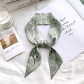 Detailed flat-lay of sage green silk scarf featuring floral prints and letter Y design - Sketch Spring Letter Y